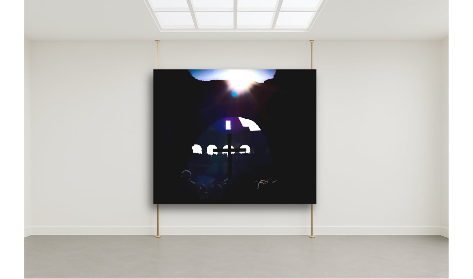 A framed night photograph on a bare white gallery wall